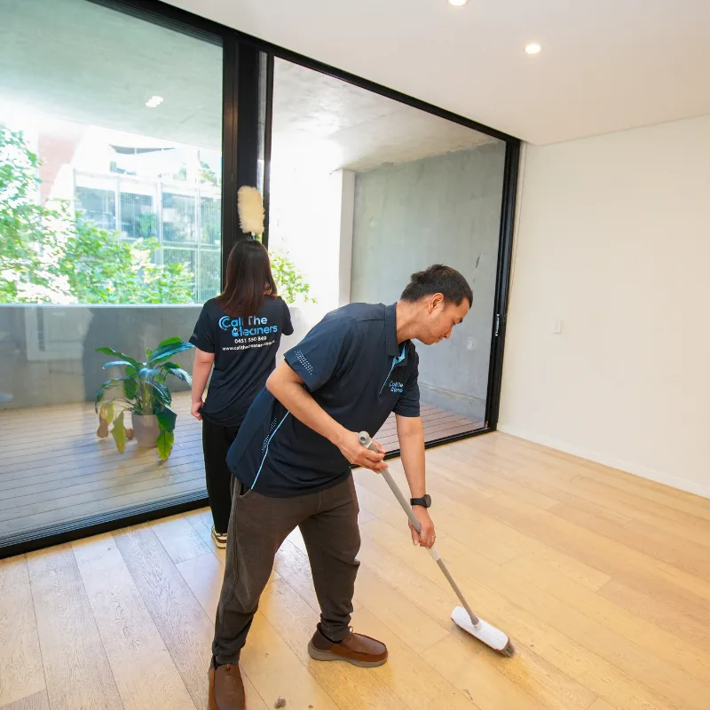 Cleaners scrubbing and sanitizing rental property for end of lease cleaning in Canberra